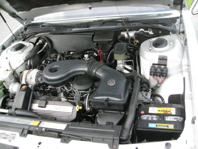 1989 Silver over Grey Metallic Cadillac DeVille 4 Door