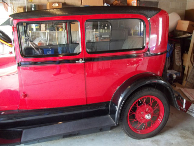 1928 red and black Ford Model A 2 door sedan