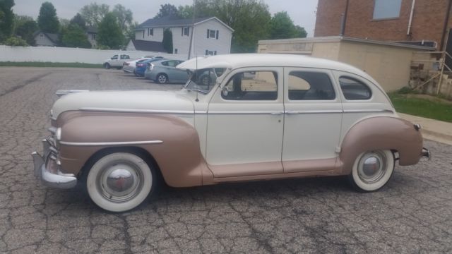 1947 gold and white Plymouth P15 Special Deluxe 4 door Sedan