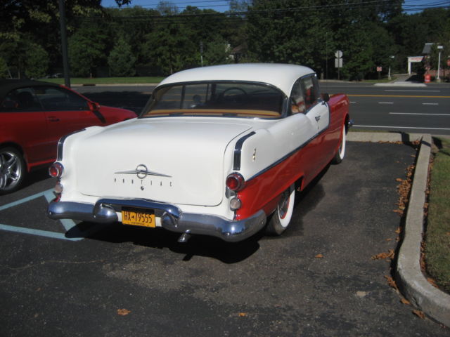 1955 red and white Pontiac Chieftain hardtop