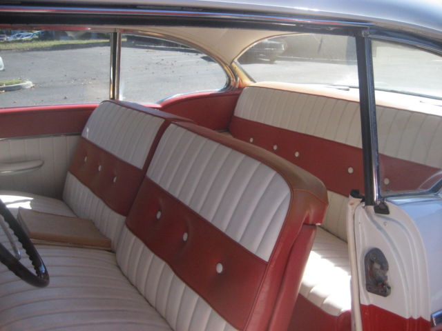 1955 red and white Pontiac Chieftain hardtop