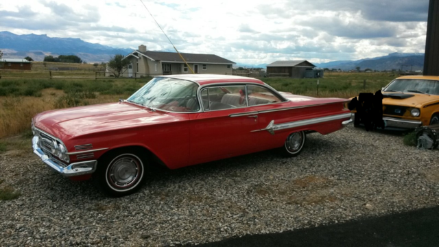 1960 red and white Chevrolet Impala Coupe