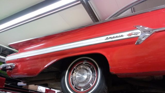 1960 red and white Chevrolet Impala Coupe