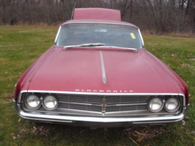 1962 burgundy Oldsmobile Starfire Coupe