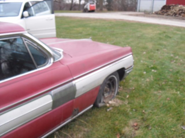 1962 burgundy Oldsmobile Starfire Coupe