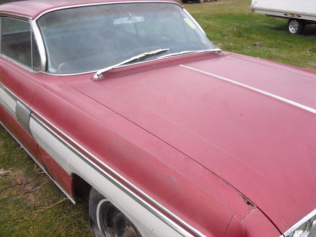 1962 burgundy Oldsmobile Starfire Coupe