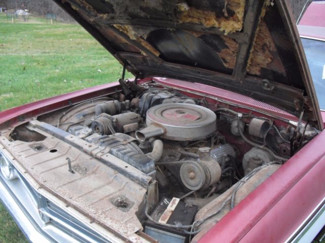 1962 burgundy Oldsmobile Starfire Coupe