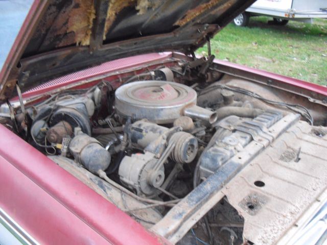 1962 burgundy Oldsmobile Starfire Coupe
