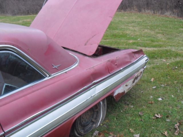 1962 burgundy Oldsmobile Starfire Coupe