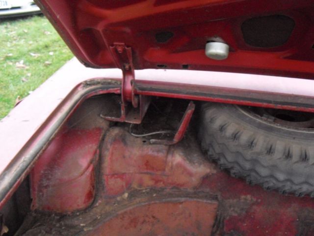 1962 burgundy Oldsmobile Starfire Coupe
