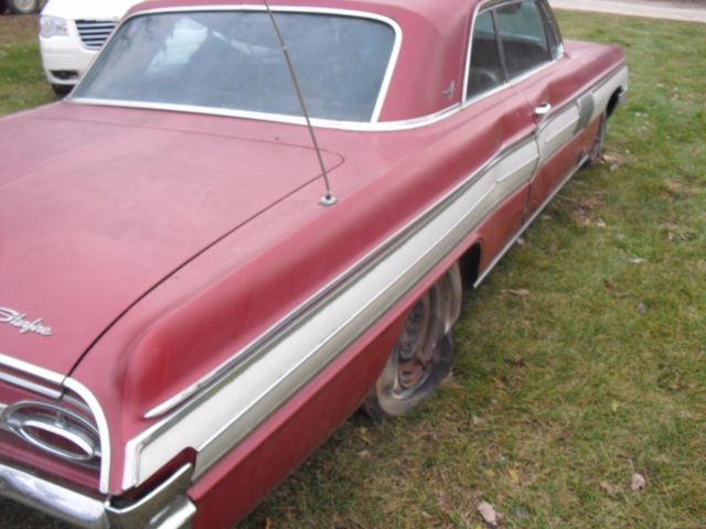 1962 burgundy Oldsmobile Starfire Coupe