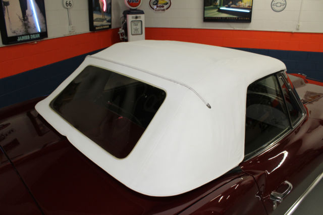 1964 maroon Chevrolet Corvette Convertible