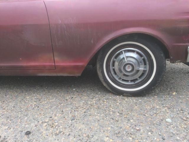 1965 maroon Chevrolet Nova Coupe