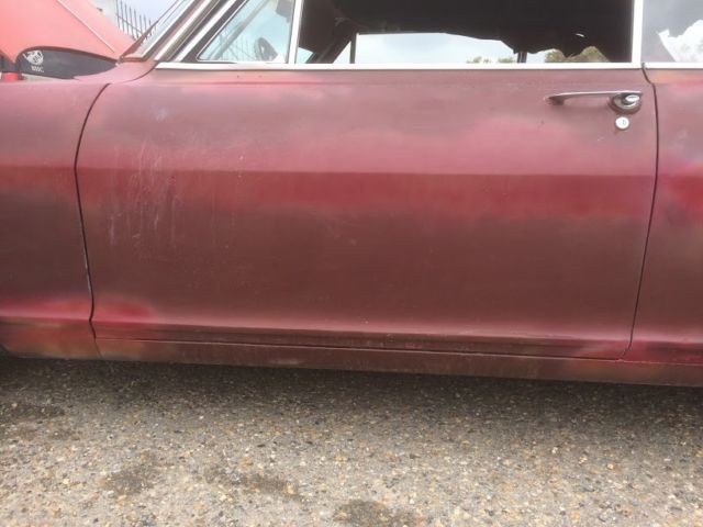 1965 maroon Chevrolet Nova Coupe