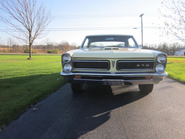 1965 yellow Pontiac GTO hardtop
