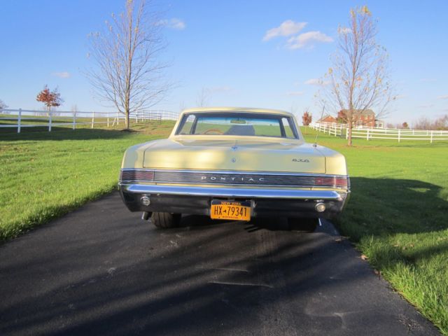 1965 yellow Pontiac GTO hardtop