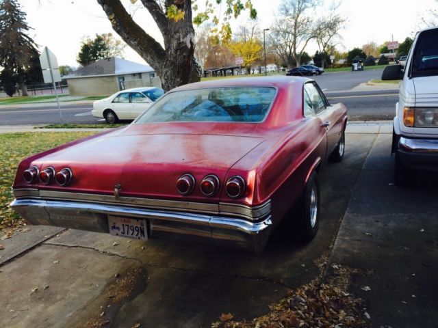 1965 red Chevrolet Impala Coupe
