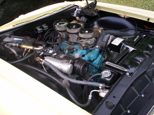 1965 yellow Pontiac 2+2 2 door conv