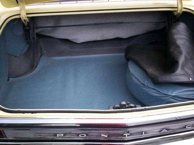 1965 yellow Pontiac 2+2 2 door conv