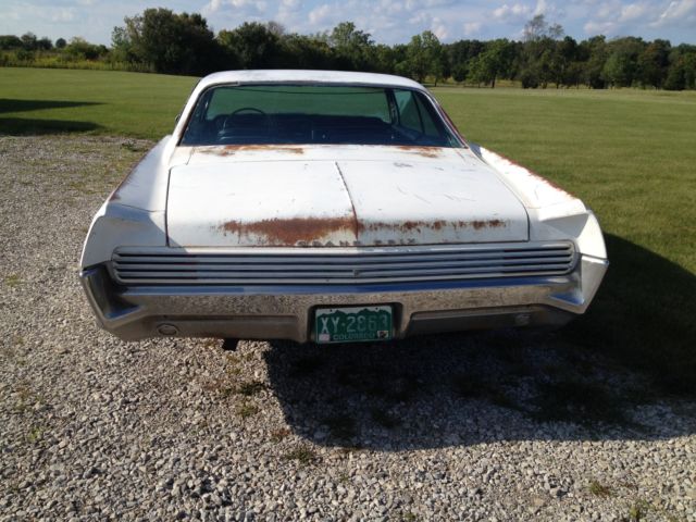 1966 white Pontiac Grand Prix Coupe