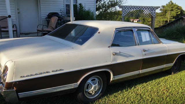 1967 white and brown Ford Galaxie Sedan