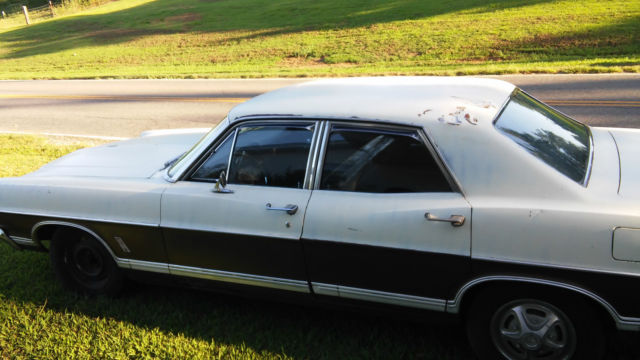 1967 white and brown Ford Galaxie Sedan