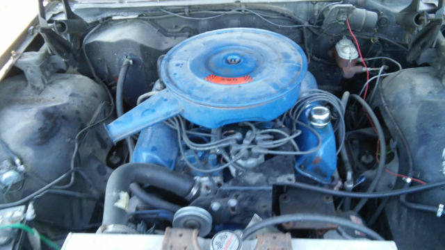 1967 white and brown Ford Galaxie Sedan