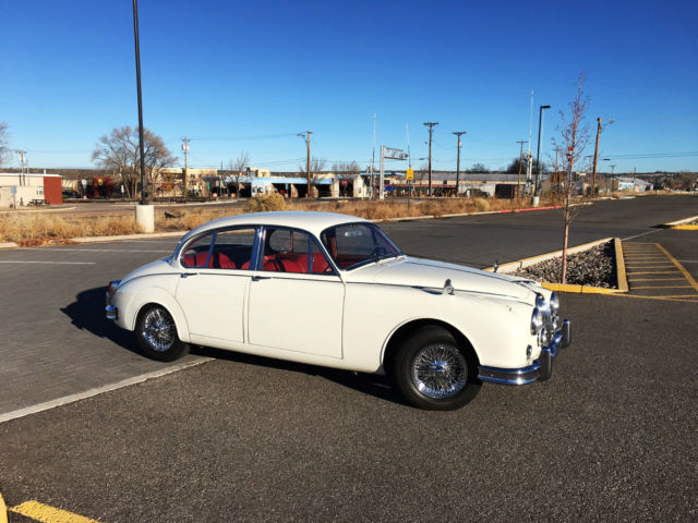 1967 cream Jaguar E-Type sedan