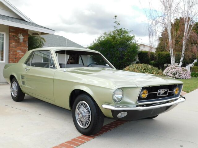 1967 green Ford Mustang coupe