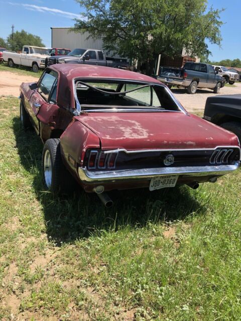 1968 maroon Ford Mustang Coupe