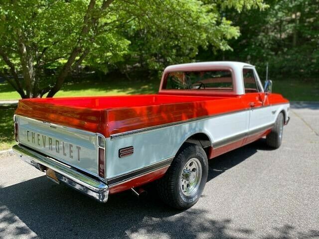 1969 orange and white Chevrolet C20 Standard cab long bed pickup