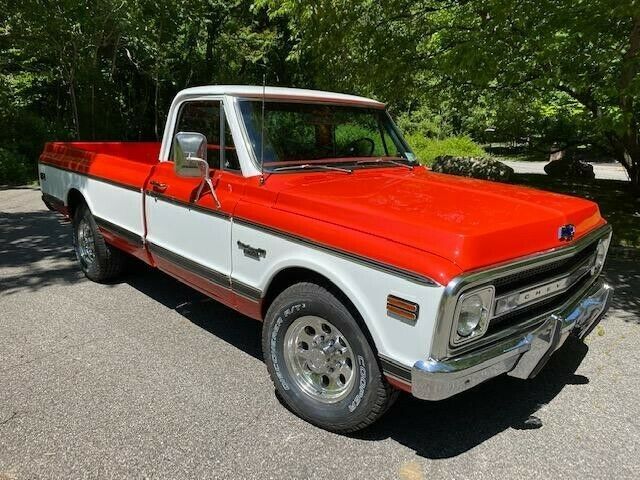 1969 orange and white Chevrolet C20 Standard cab long bed pickup