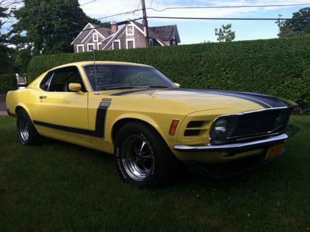 1970 yellow and black Ford Mustang Coupe