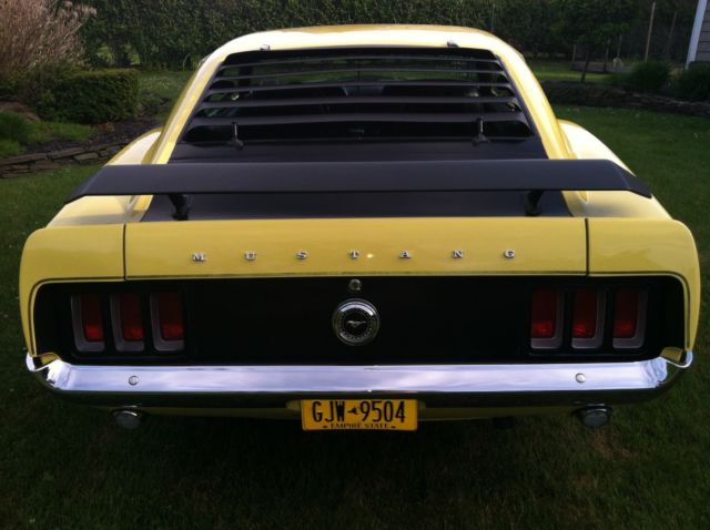 1970 yellow and black Ford Mustang Coupe