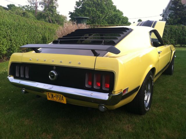 1970 yellow and black Ford Mustang Coupe