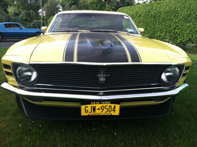1970 yellow and black Ford Mustang Coupe