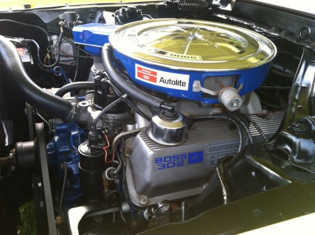 1970 yellow and black Ford Mustang Coupe