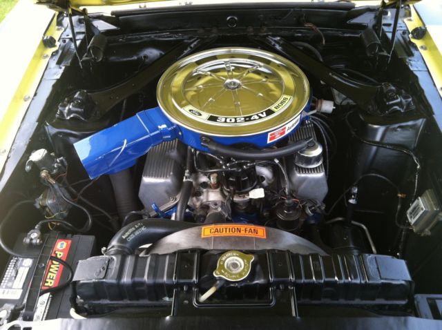 1970 yellow and black Ford Mustang Coupe