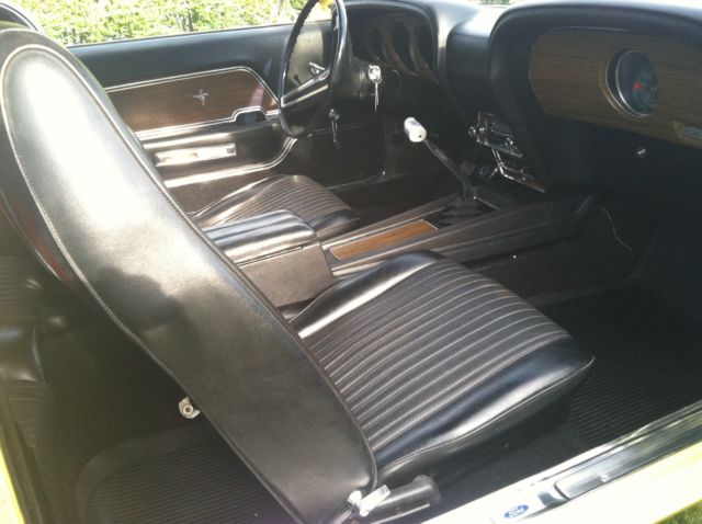 1970 yellow and black Ford Mustang Coupe