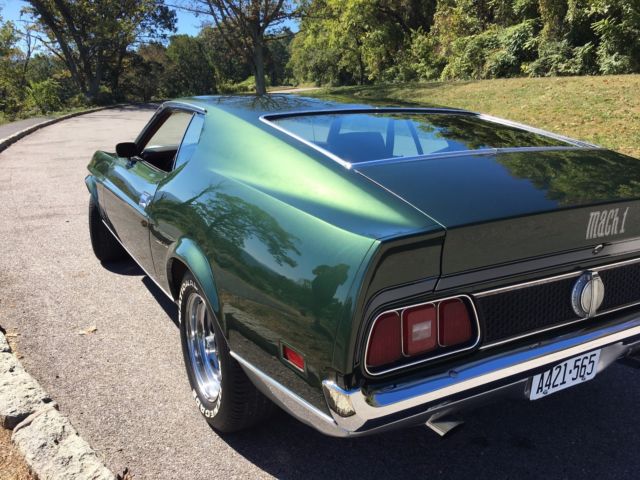 1971 green and silver Ford Mustang fastback