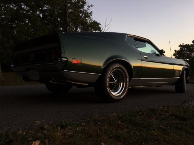 1971 green and silver Ford Mustang fastback