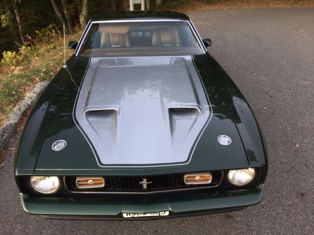 1971 green and silver Ford Mustang fastback