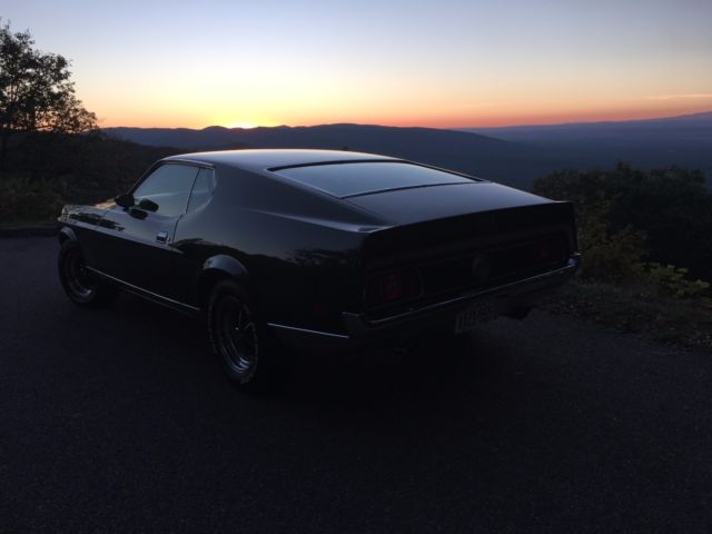 1971 green and silver Ford Mustang fastback
