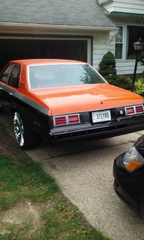 1976 Orange, Gray, & Black Chevrolet Nova Sedan