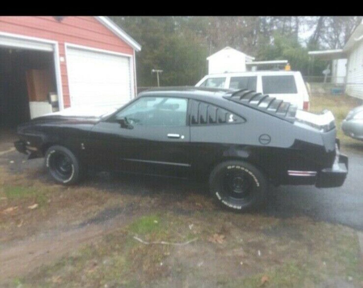 1978 white and green Ford Mustang 2 door fastback