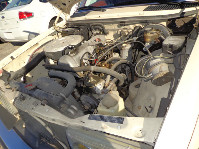 1981 cream Mercedes-Benz 200-Series Sedan