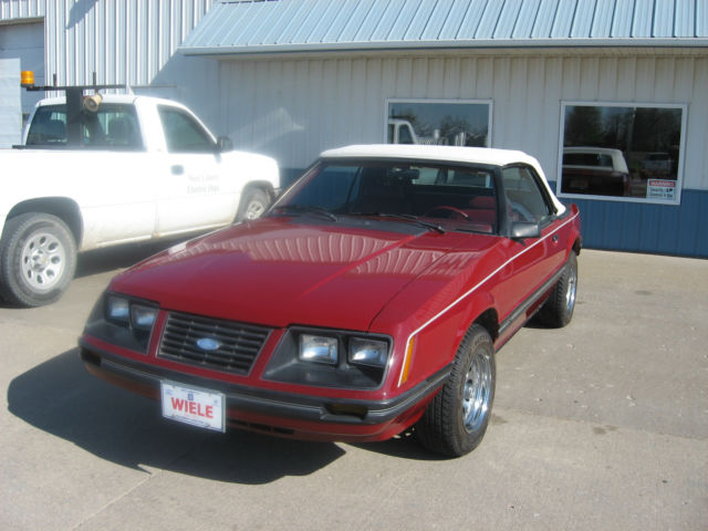 1983 marroon Ford Mustang Convertible
