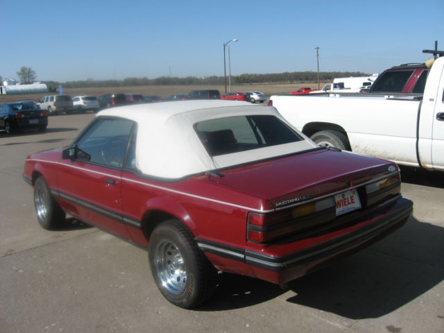 1983 marroon Ford Mustang Convertible