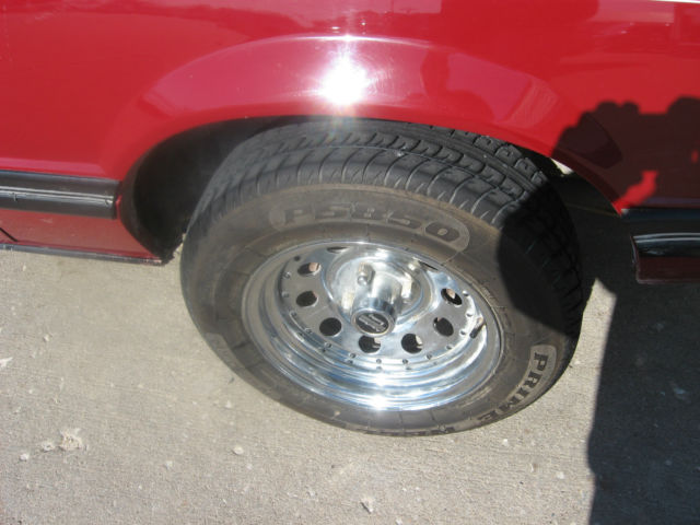 1983 marroon Ford Mustang Convertible