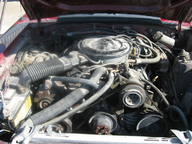 1983 marroon Ford Mustang Convertible